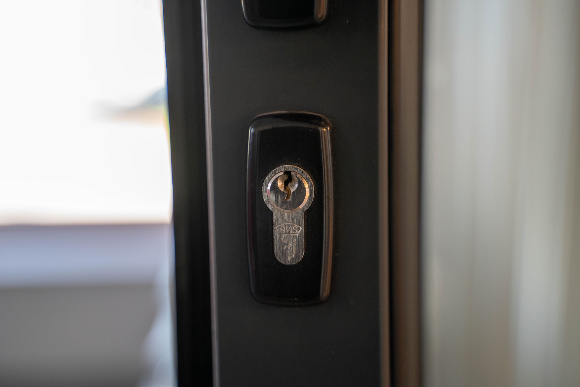 A cylinder lock in a dark front door