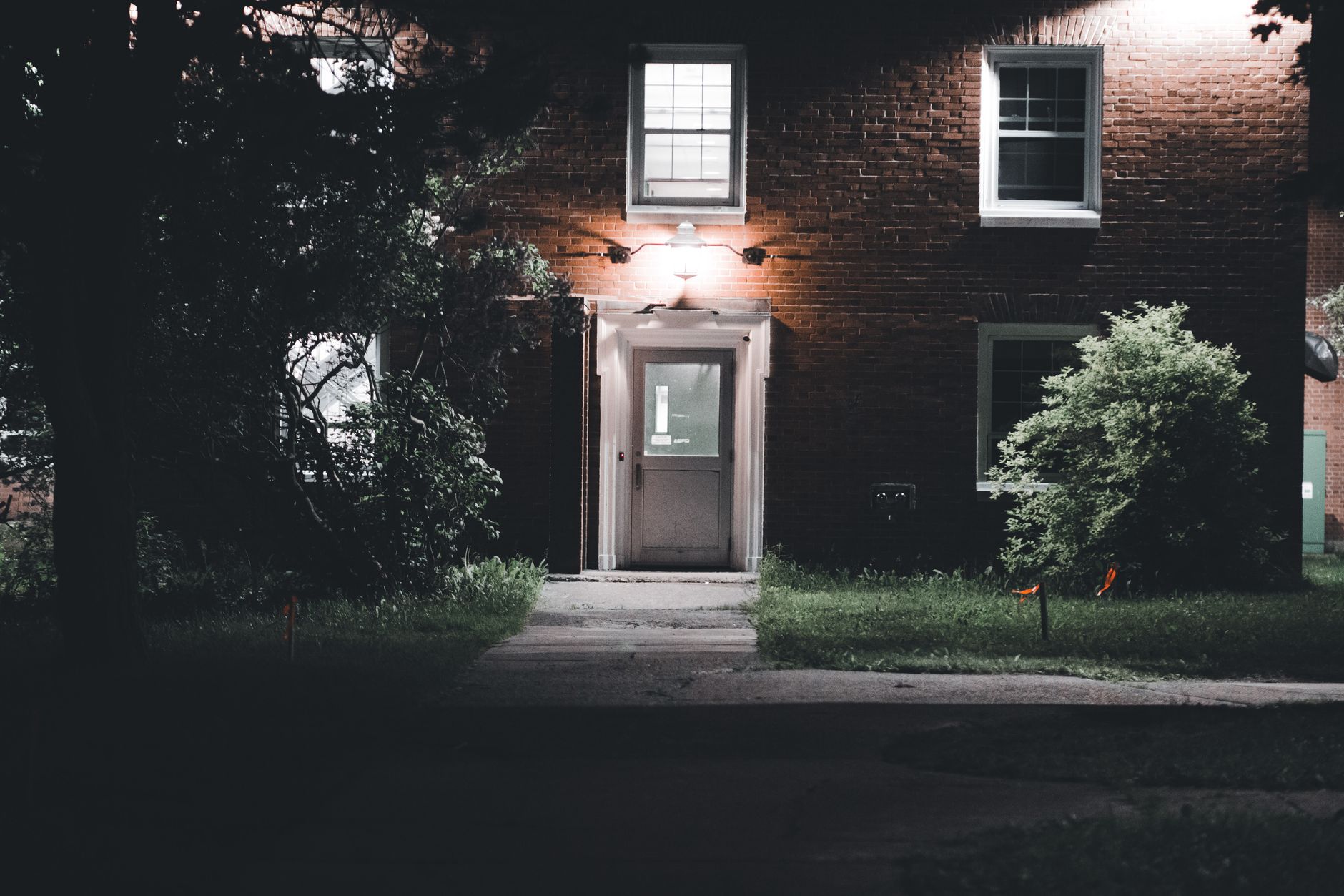 A house at night with the front door lit
