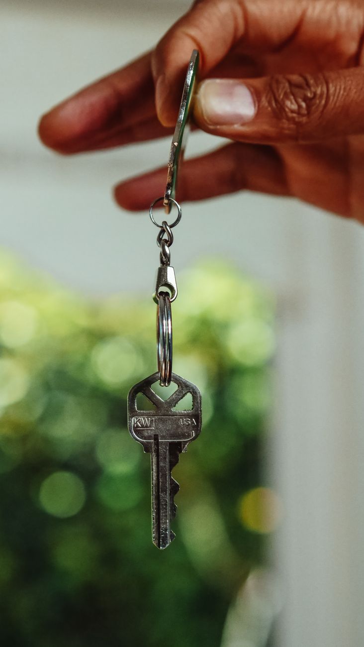 A hand holding a house key