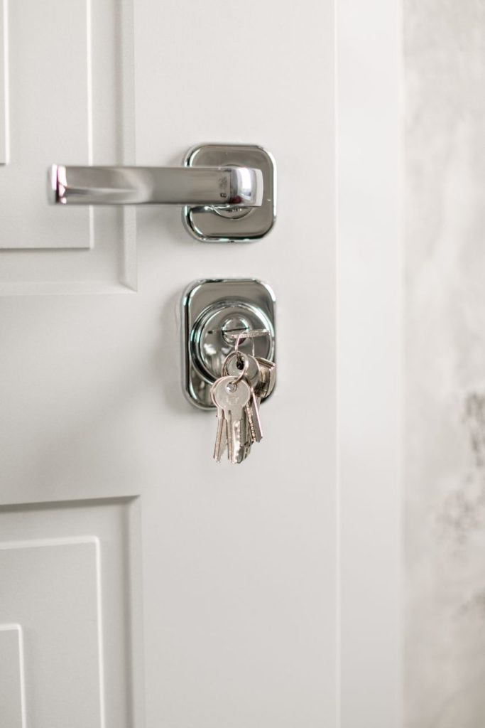 Keys in a cylinder lock on a white door