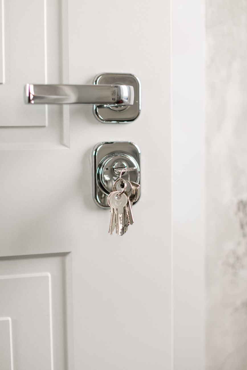 Keys in a cylinder lock on a white door