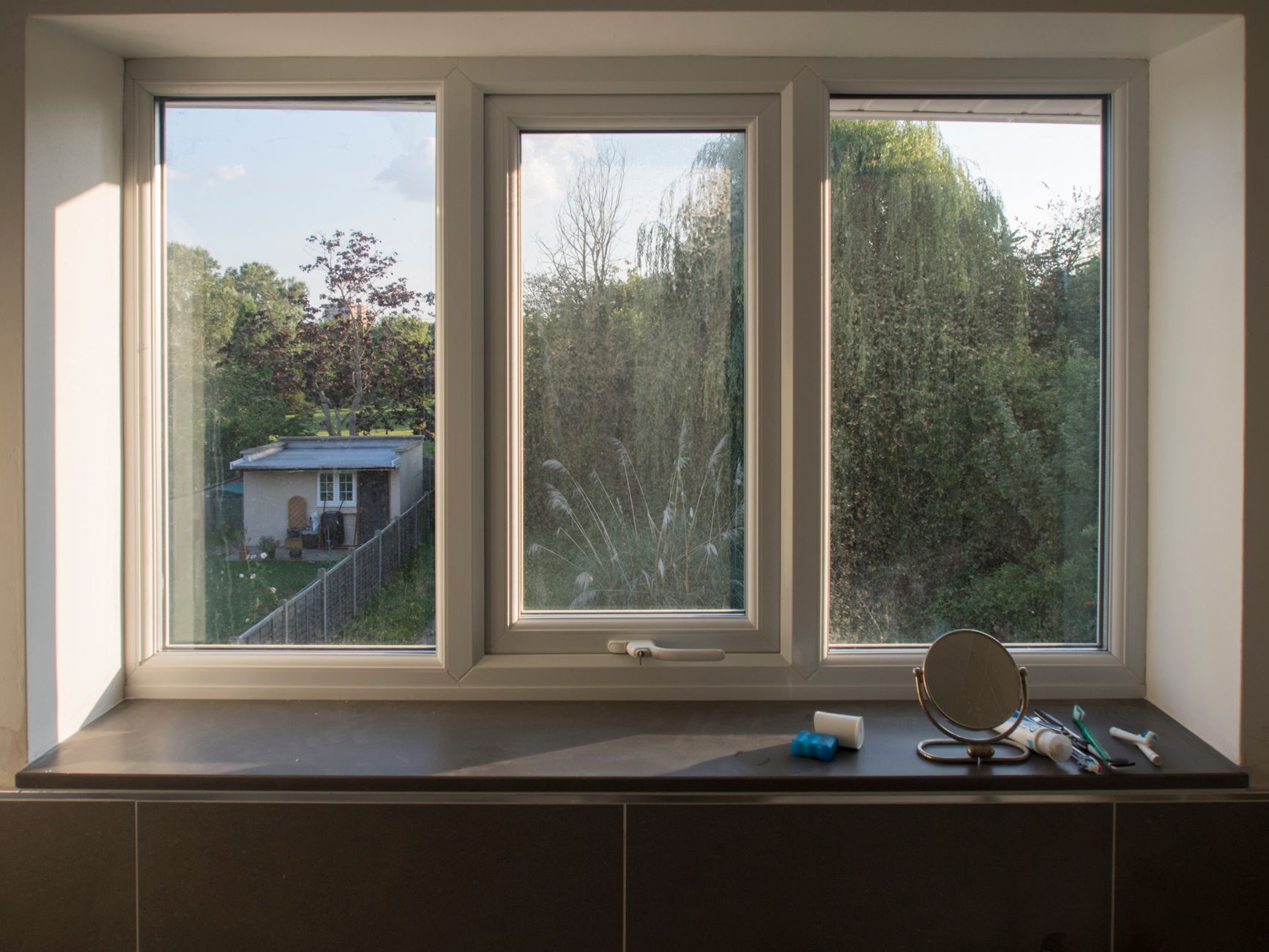 A modern window looking onto a garden
